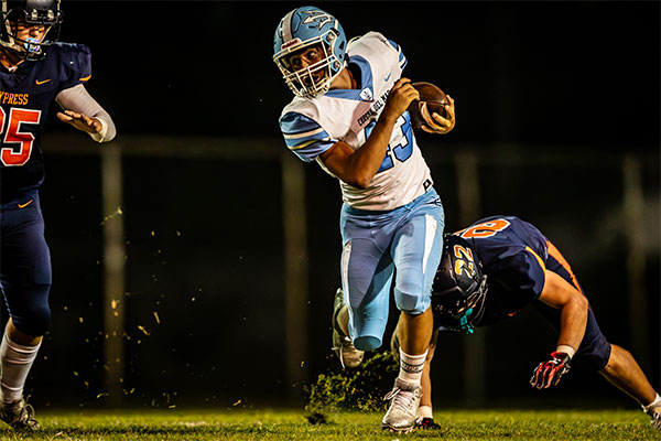 Sam-reed Dickens (#13) breaks loose from defender for extra yards.