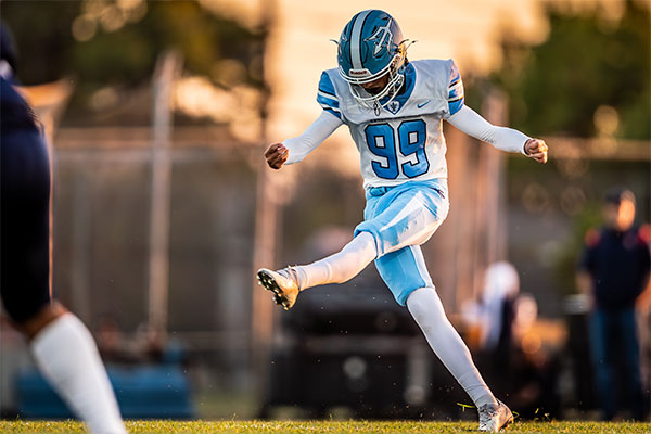 Chase Lawton (#99) kicking off the game with a boot.