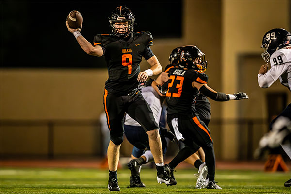 Brady Edmunds (#9) finds an open receiver down field.