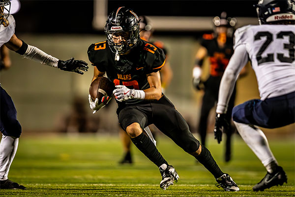 Faris Shehadeh (#13) Splits defenders for a gain of yards.