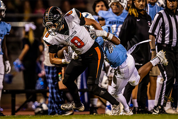 Gabe Bryant (#8) fighting to stay off the ground.