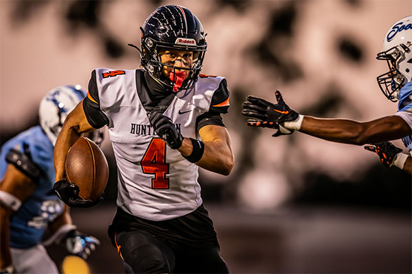 Troy Foster (#4) splits the defenders for a gain of yards.