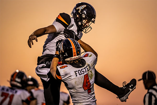 Troy Foster (#4) celebrating with fellow teammate.