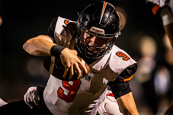 Brady Edmunds (#9) fighting to stay off the ground.