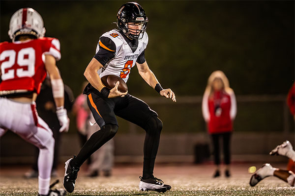 Brady Edmunds (#9) tucks the ball to turn up for a gain of yards.