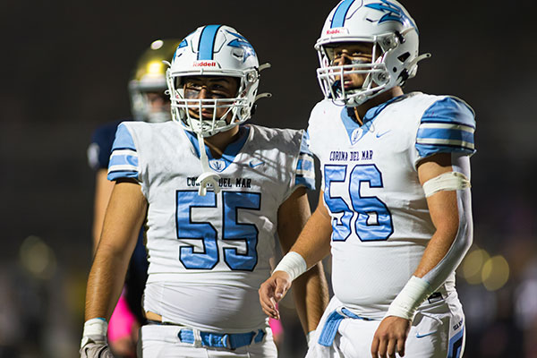 Damian Zeno-Herrera (#55) and Landon Rucker (#56) looking to the sideline for the next play.