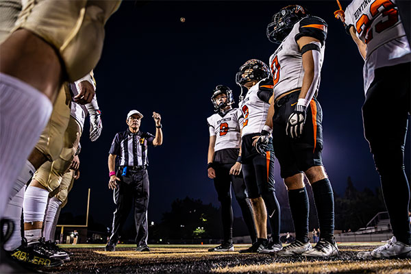 Team Captains Brady Edmunds (#9), Niko Lopez (#2), Trent Clark (#0), and Micha Riola (#23) wait on the coin toss. Photos by JPWest Media