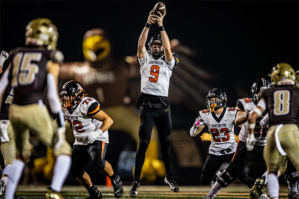 Brady Edmunds (#9) catches a high snap.