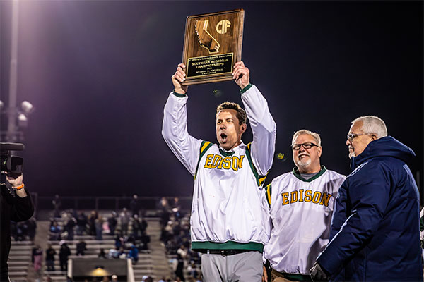 E-x-GH-E-Coaches-holding-up-Championship-Plaque